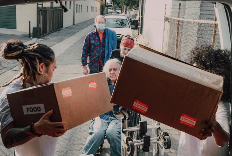 Volunteers assist in food and supply distribution, offering hope and support to those in need.